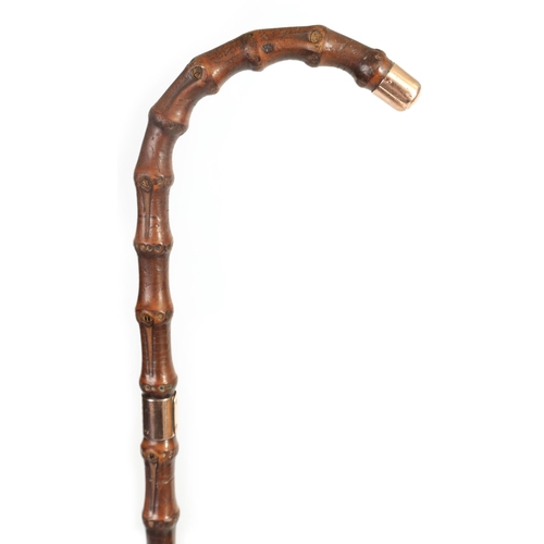 462 - A LATE 19TH CENTURY 9CT GOLD TIPPED BAMBOO WALKING STICK BY BRIGG with hooped handle and rose gold t... 