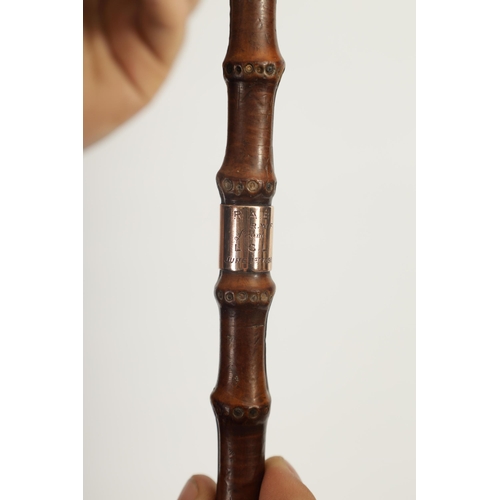 462 - A LATE 19TH CENTURY 9CT GOLD TIPPED BAMBOO WALKING STICK BY BRIGG with hooped handle and rose gold t... 