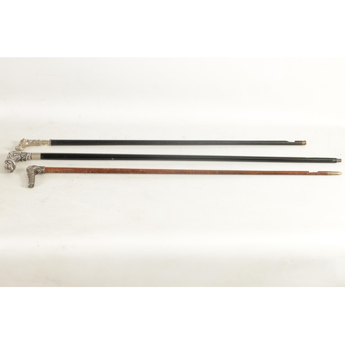 464 - THREE LATE 19TH CENTURY SILVER METAL MOUNTED WALKING CANES depicting a horse stirrup and hat handle ... 