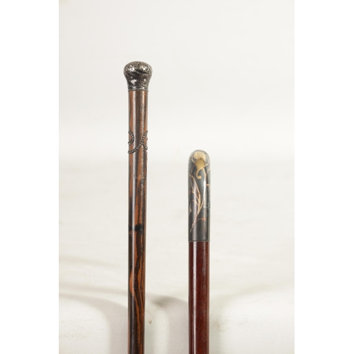 467 - TWO EARLY 20TH CENTURY FRENCH WALKING CANES one with Art Nouveau gold inlaid handle and tapering mah... 