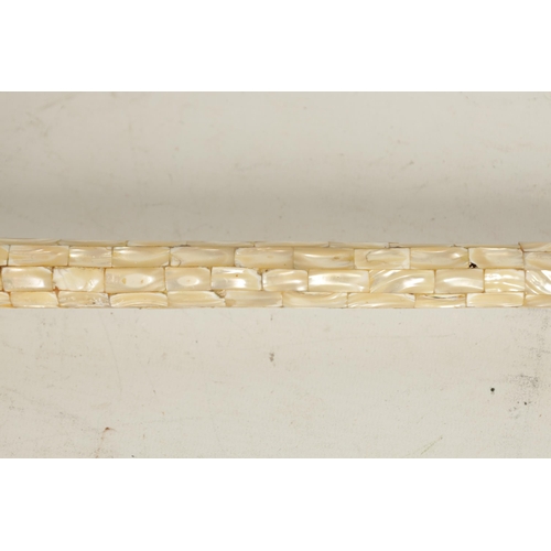 472 - A 19TH / 20TH CENTURY MOTHER OF PEARL VENNERED WALKING CANE having brick effect design with bulbous ... 