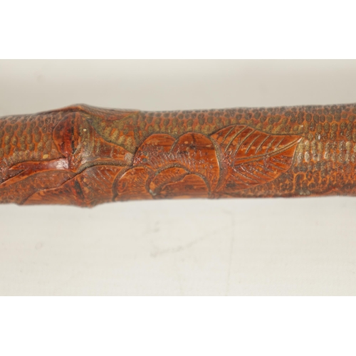 475 - A 19TH CENTURY WEIGHTED ORIENTAL CARVED BAMBOO WALKING CANE the root handle on a bamboo cane finely ... 