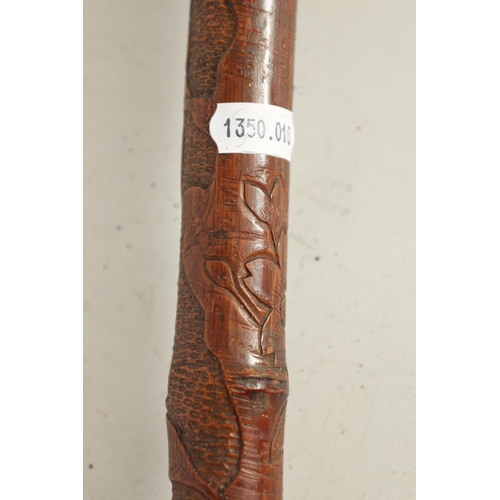 475 - A 19TH CENTURY WEIGHTED ORIENTAL CARVED BAMBOO WALKING CANE the root handle on a bamboo cane finely ... 