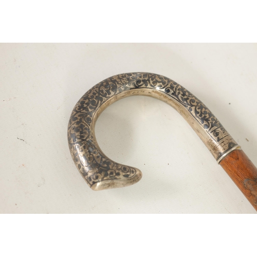 481 - A RUSSIAN SILVER NIELLO HANDLED WALKING CANE the handle with scroll work decoration on a tapering fr... 