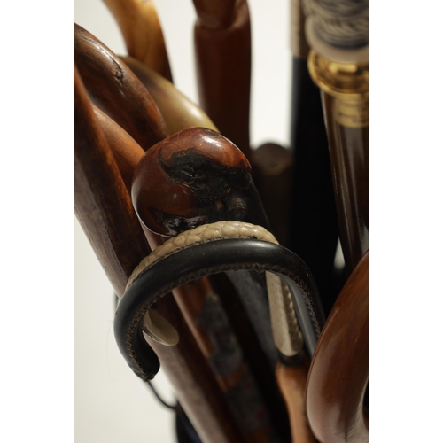 485 - A SELECTION OF 19TH AND 20TH CENTURY WALKING STICKS TOGETHER WITH A TAPERED OAK AND IRON COOPERED ST... 