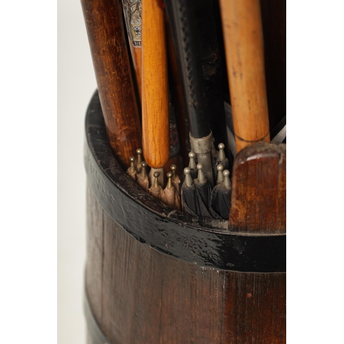 485 - A SELECTION OF 19TH AND 20TH CENTURY WALKING STICKS TOGETHER WITH A TAPERED OAK AND IRON COOPERED ST... 