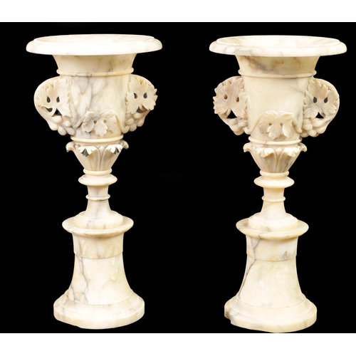 489 - A PAIR OF 19TH CENTURY FRENCH ALABASTER MANTEL URNS of sectional form with pedestal bases and leaf-c... 