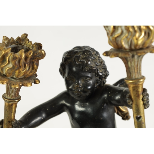 490 - A PAIR OF EARLY 19TH CENTURY FRENCH GILT BRONZE AND ROUGE MARBLE TWO BRANCH CHERUB CANDELABRA modell... 