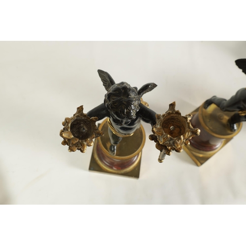 490 - A PAIR OF EARLY 19TH CENTURY FRENCH GILT BRONZE AND ROUGE MARBLE TWO BRANCH CHERUB CANDELABRA modell... 