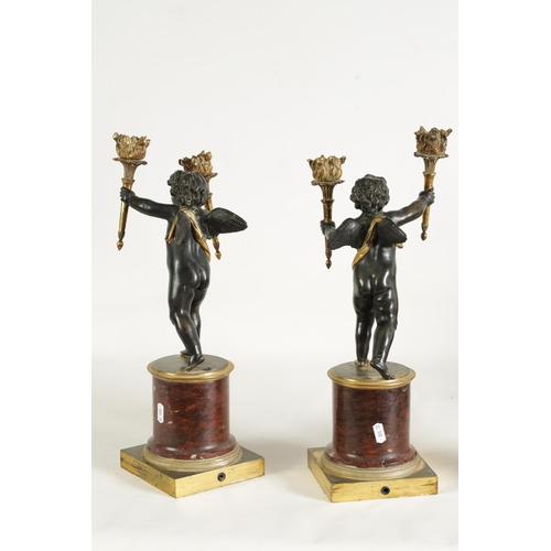 490 - A PAIR OF EARLY 19TH CENTURY FRENCH GILT BRONZE AND ROUGE MARBLE TWO BRANCH CHERUB CANDELABRA modell... 