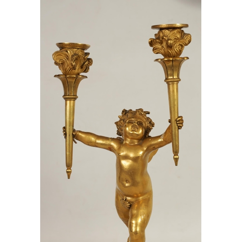 492 - A PAIR OF 18TH/19TH CENTURY BRONZE AND ORMOLU CANDELABRA formed as standing cherubs holding torches;... 