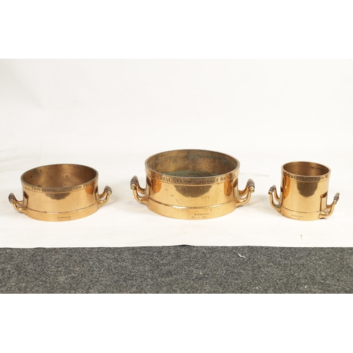 495 - A SET OF THREE 19TH CENTURY IMPERIAL STANDARD CAST BRASS GRAIN MEASURES BY BATE LONDON fitted with t... 