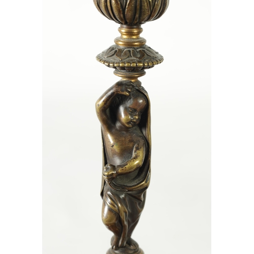 500 - A PAIR OF 19TH CENTURY BRONZE FIGURAL CANDLESTICKS the fluted sconces with removable rims on leaf en... 