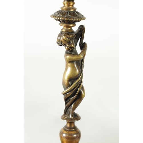 500 - A PAIR OF 19TH CENTURY BRONZE FIGURAL CANDLESTICKS the fluted sconces with removable rims on leaf en... 