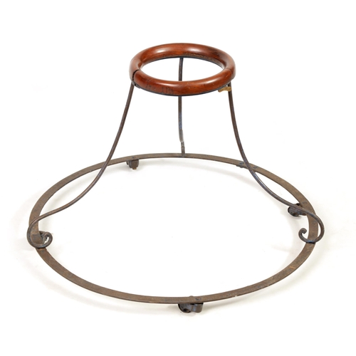 505 - A 19TH CENTURY IRONWORK AND MAHOGANY BABY WALKER the spreading rivetted base on four revolving casto... 