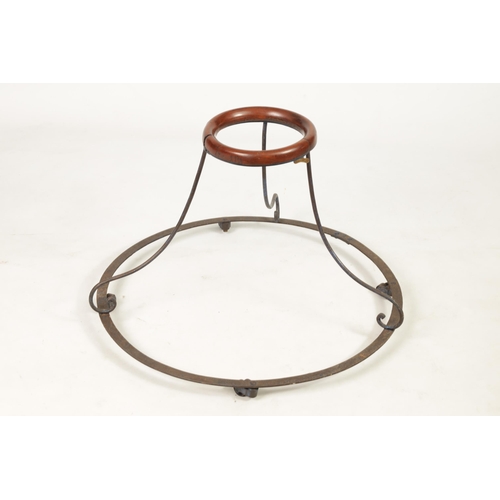 505 - A 19TH CENTURY IRONWORK AND MAHOGANY BABY WALKER the spreading rivetted base on four revolving casto... 