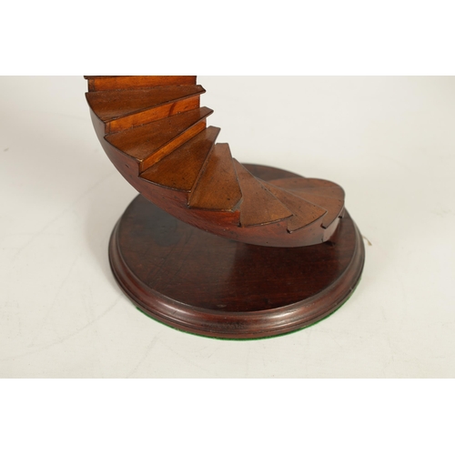 507 - A 20TH CENTURY MAHOGANY FRENCH MODEL OF A SPIRAL STAIRCASE mounted on circular moulded edge plinth b... 