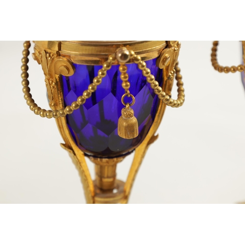 510 - A FINE PAIR OF REGENCY FRENCH ORMOLU AND BLUE GLASS REVERSIBLE CASOLETTES with changeable urn and ca... 