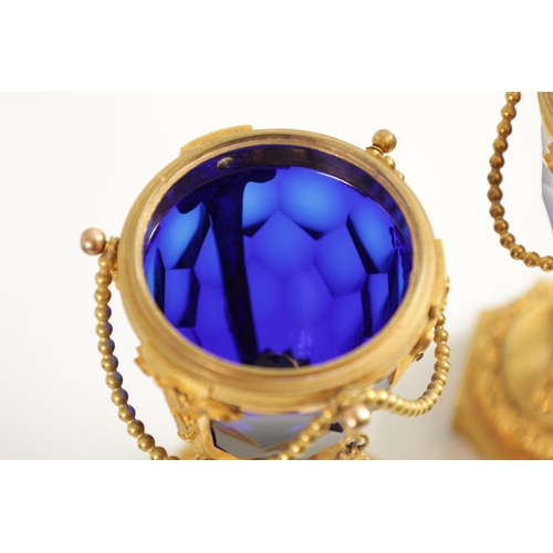 510 - A FINE PAIR OF REGENCY FRENCH ORMOLU AND BLUE GLASS REVERSIBLE CASOLETTES with changeable urn and ca... 