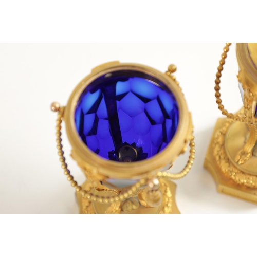 510 - A FINE PAIR OF REGENCY FRENCH ORMOLU AND BLUE GLASS REVERSIBLE CASOLETTES with changeable urn and ca... 