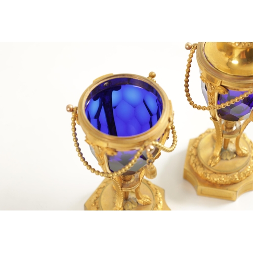 510 - A FINE PAIR OF REGENCY FRENCH ORMOLU AND BLUE GLASS REVERSIBLE CASOLETTES with changeable urn and ca... 