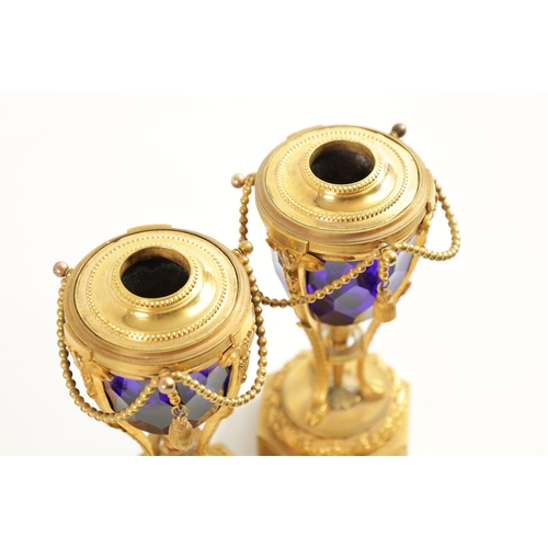 510 - A FINE PAIR OF REGENCY FRENCH ORMOLU AND BLUE GLASS REVERSIBLE CASOLETTES with changeable urn and ca... 