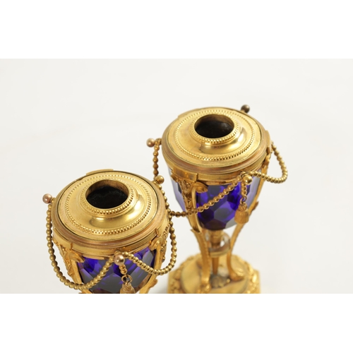 510 - A FINE PAIR OF REGENCY FRENCH ORMOLU AND BLUE GLASS REVERSIBLE CASOLETTES with changeable urn and ca... 