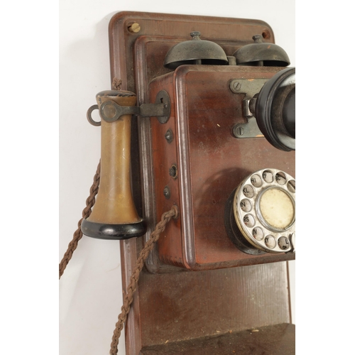 511 - TWO EARLY 20TH CENTURY TELEPHONES one wall mounted in a mahogany case, the other stick phone with Ba... 