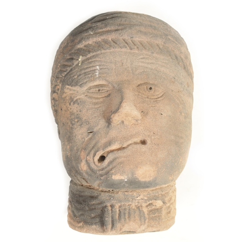 517 - AN EARLY EASTERN CARVED RED SANDSTONE HEAD realistically modelled wearing head dress (36cm high 24cm... 