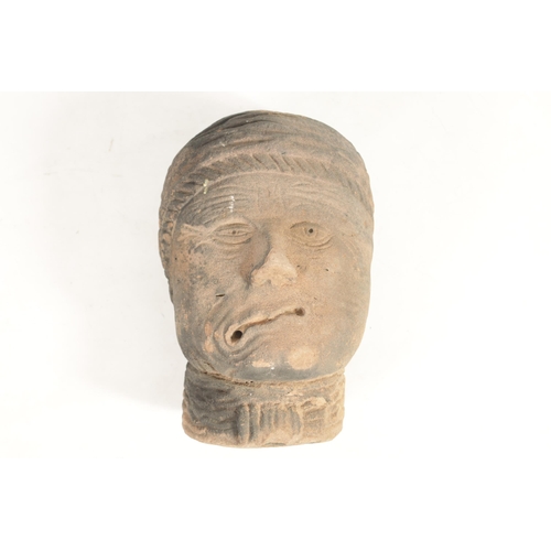 517 - AN EARLY EASTERN CARVED RED SANDSTONE HEAD realistically modelled wearing head dress (36cm high 24cm... 