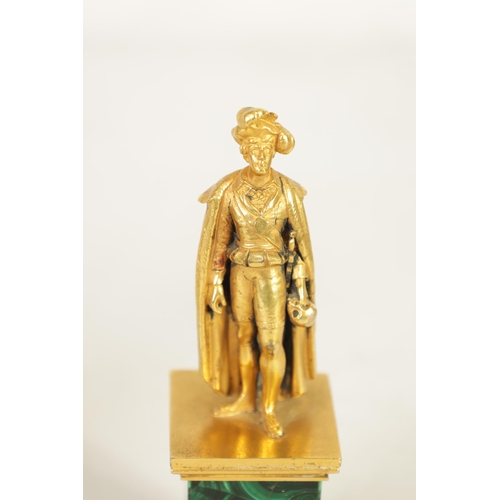 519 - A 19TH CENTURY ORMOLU AND MALACHITE FIGURAL SCULPTURE depicting a robed male figure standing and hol... 