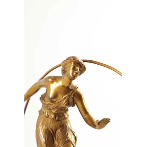 520 - AN ART DECO GILT BRONZE FIGURE GROUP depicitng a 'Hoop Girl' mounted on a stepped onyx base. (18cm h... 