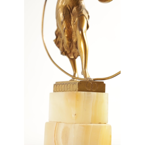 520 - AN ART DECO GILT BRONZE FIGURE GROUP depicitng a 'Hoop Girl' mounted on a stepped onyx base. (18cm h... 