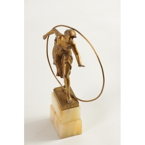 520 - AN ART DECO GILT BRONZE FIGURE GROUP depicitng a 'Hoop Girl' mounted on a stepped onyx base. (18cm h... 