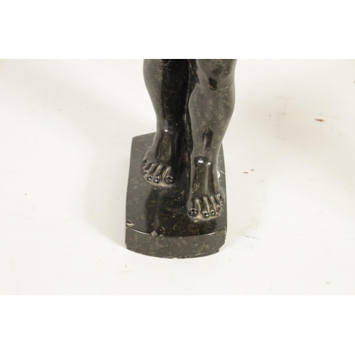 523 - AN UNUSUAL CARVED MARBLE EGYPTIAN STYLE FIGURE OF A STANDING MAN mounted on a rectangular shaped bas... 