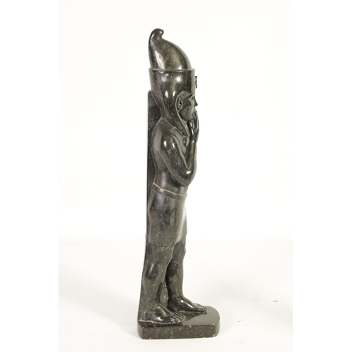 523 - AN UNUSUAL CARVED MARBLE EGYPTIAN STYLE FIGURE OF A STANDING MAN mounted on a rectangular shaped bas... 