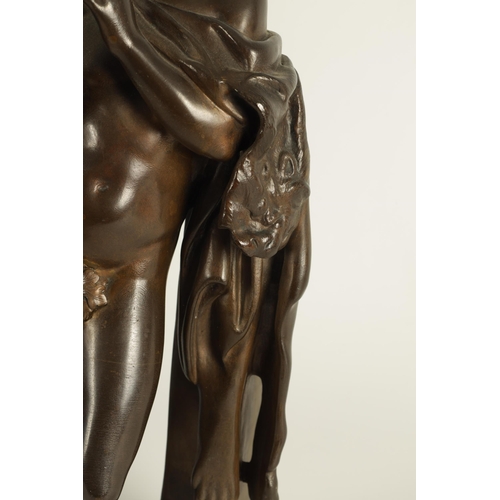 525 - A 19TH CENTURY BRONZE SCULPTURE OF THE SATYR “MARSYAS” PLAYING THE FLUTE leaning against a pillar - ... 