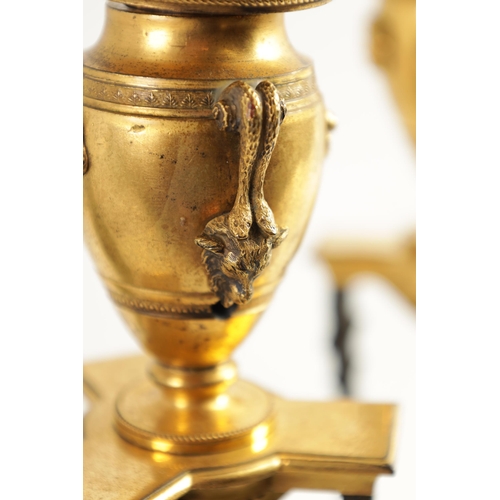 537 - A PAIR OF REGENCY FRENCH EMPIRE BRONZE AND ORMOLU CANDLESTICKS with urn shaped tops above triform su... 