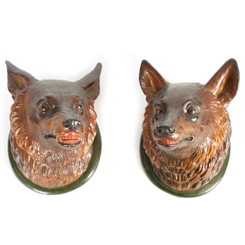 545 - A PAIR OF LATE 19TH CENTURY POLYCHROME TERRACOTTA FOX HEADS modelled as a dog fox and vixen on green... 