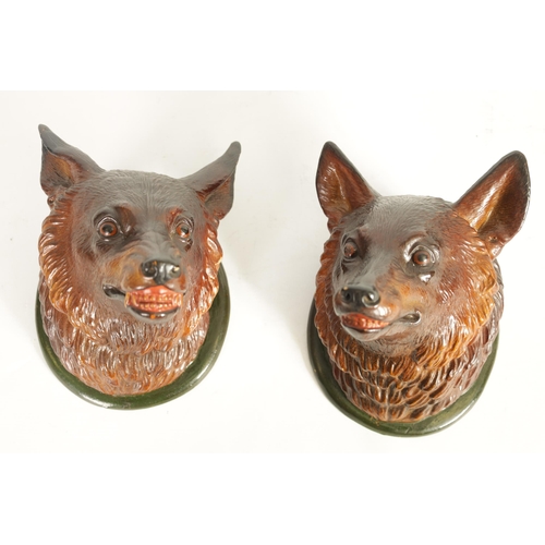 545 - A PAIR OF LATE 19TH CENTURY POLYCHROME TERRACOTTA FOX HEADS modelled as a dog fox and vixen on green... 