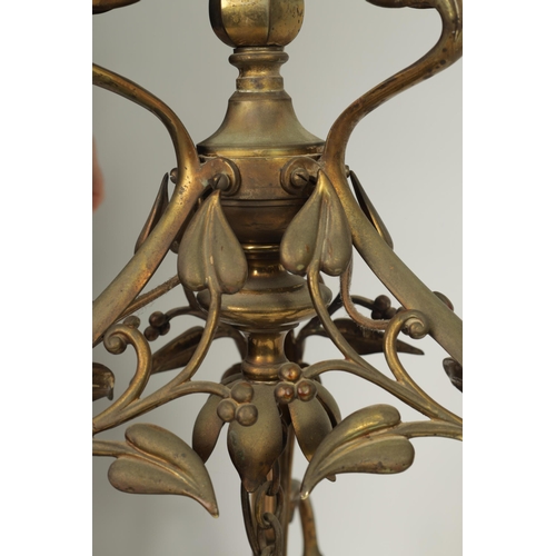 551 - AN ART NOUVEAU BRASS BENSON STYLE FOUR SHADE CEILING LIGHT with scrolling branchwork supporting five... 