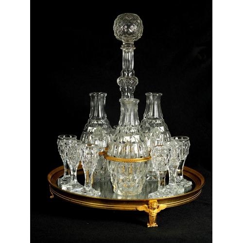 555 - A LATE 19TH CENTURY FRENCH ORMOLU AND CUT GLASS DECANTER SET with three bulbous cut glass decanters ... 