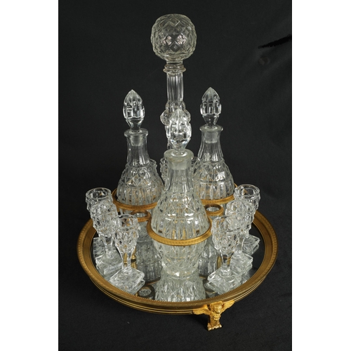 555 - A LATE 19TH CENTURY FRENCH ORMOLU AND CUT GLASS DECANTER SET with three bulbous cut glass decanters ... 