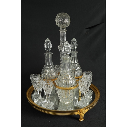 555 - A LATE 19TH CENTURY FRENCH ORMOLU AND CUT GLASS DECANTER SET with three bulbous cut glass decanters ... 