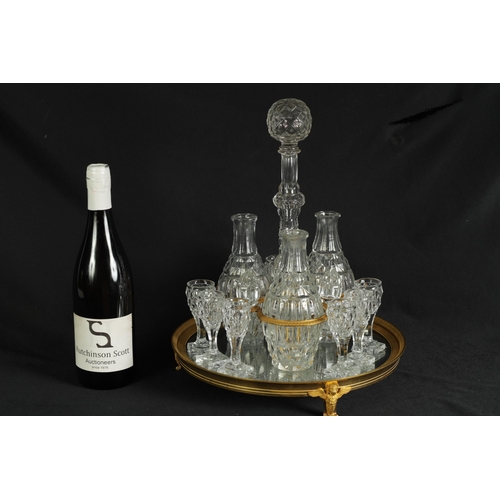 555 - A LATE 19TH CENTURY FRENCH ORMOLU AND CUT GLASS DECANTER SET with three bulbous cut glass decanters ... 