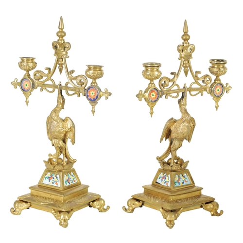 556 - A PAIR OF LATE 19TH CENTURY BRASS AESTHETIC PERIOD DOUBLE BRANCH CANDELABRA set with porcelain panel... 