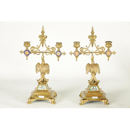 556 - A PAIR OF LATE 19TH CENTURY BRASS AESTHETIC PERIOD DOUBLE BRANCH CANDELABRA set with porcelain panel... 