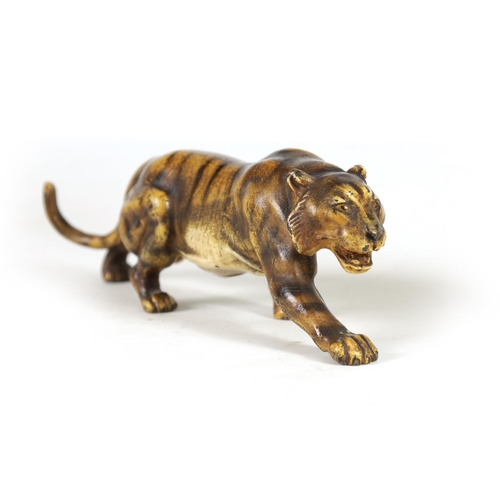 557 - A LATE 19TH-CENTURY BERGMAN-STYLE COLD-PAINTED BRONZE SCULPTURE OF A PROWLING TIGER (21cm long)