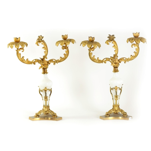 561 - A PAIR OF 19TH CENTURY TWO BRANCH ORMOLU AND OPAQUE GLASS CANDELABRA with leaf cast branchwork arms ... 