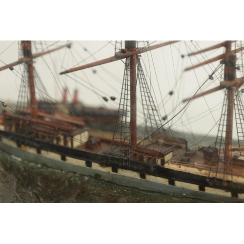 581 - A 19TH CENTURY SHIP'S DIORAMA modelled as a three-masted vessel in a painted sea and ebonised glazed... 